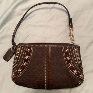 Coach wristlet. Black with silver designs